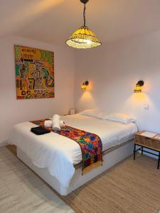 a bedroom with a bed with a stuffed animal on it at Domaine la Héroïca in Maisonnais
