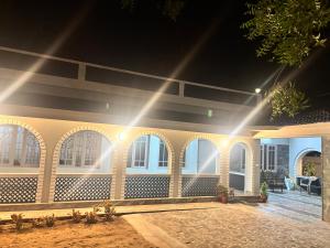 a house with a row of windows and lights at Oceanbliss Villa in Pallipuram