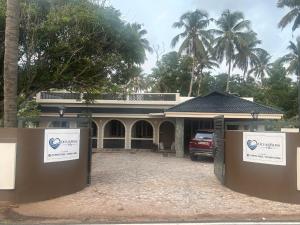 a house with a car parked in front of it at Oceanbliss Villa in Pallipuram