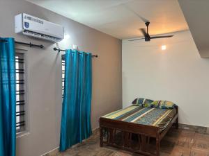 a bedroom with a bed and a air conditioner at Oceanbliss Villa in Pallipuram