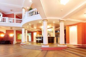 a large lobby with a staircase in a building at Severnaya Hotel in Petrozavodsk