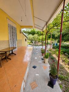 an empty patio with a table and potted plants at Garden Oasis in Vlore in Vlorë
