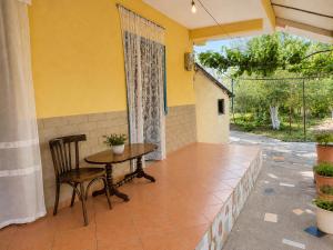 a patio with a table and chairs and a window at Garden Oasis in Vlore in Vlorë +4 photos