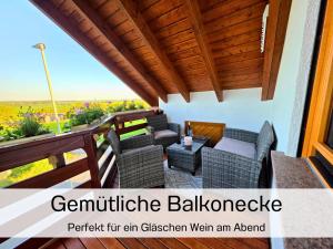 a patio with chairs and a table on a balcony at Ferienwohnung Matheaperle mit Infrarotkabine in Nidda