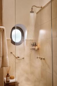 a shower with a glass door in a bathroom at Miravida Soho Hotel & Wine Bar in Buenos Aires +70 photos