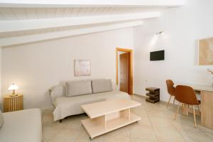 a living room with a couch and a table at Fissas Rooms in Syvota