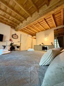 a large room with a large bed and a kitchen at La Dimora del Brocante in Cuneo