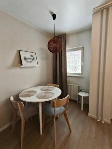 a dining room with a table and chairs and a window at Room Sonaatti in Savonlinna