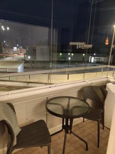 a table and two chairs in front of a window at Room Sonaatti in Savonlinna