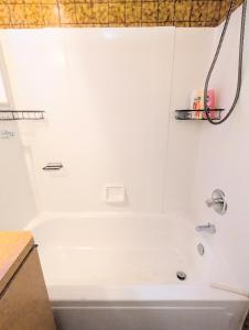 a bathroom with a white tub and a sink at 1 central ave in Old Orchard Beach +15 photos