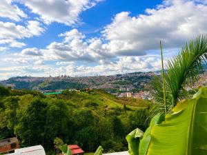 a view of a city on a hill at ECOHostal Las Hamacas Rincon Del Árbol in Villamaría