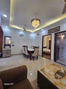 a dining room with a table and chairs in a room at Eknav Villa in Kharar