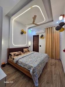 a bedroom with a bed with a large window at Eknav Villa in Kharar
