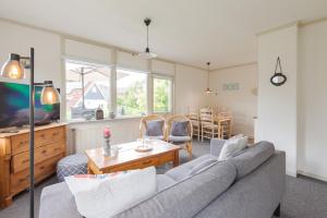 a living room with a couch and a table at Irina - Peaceful Holiday Home near Lauwersmeer National Park in Anjum