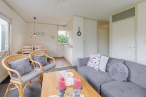 a living room with a couch and chairs and a table at Irina - Peaceful Holiday Home near Lauwersmeer National Park in Anjum