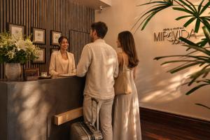 a man and a woman standing at a counter at Miravida Soho Hotel & Wine Bar in Buenos Aires