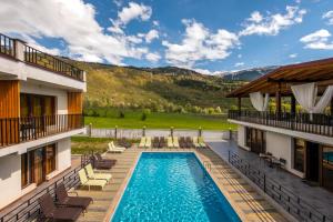 a pool in the middle of a building with a resort at Anne's Hotel in Mestia in Mestia