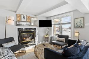 a living room with a couch and a fireplace at Private Oceanfront Suite Hot Tub & Fireplace in Lunenburg