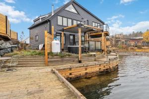 a house on a dock on a body of water at Private Oceanfront Suite Hot Tub & Fireplace in Lunenburg
