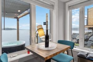a bathroom with a tub and a table and chairs at Private Oceanfront Suite Hot Tub & Fireplace in Lunenburg +39 photos