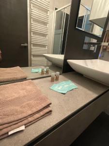 a bathroom with a sink and towels on a counter at Casa Estense in Lido degli Estensi +15 photos