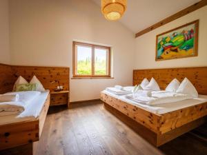 a bedroom with two beds and a window at Grasine 58 in Lake Pressegg