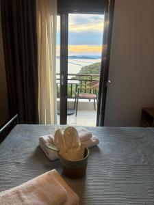 a room with a table with a view of the ocean at Thanos ,Rooms and Apartments in Ouranoupoli