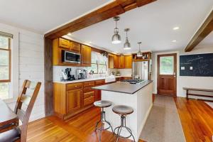 a kitchen with wooden cabinets and a counter top at High Street Retreat in Cavendish