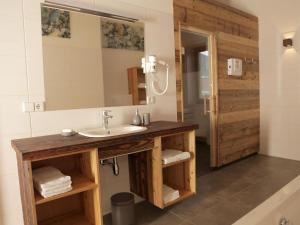 a bathroom with a sink and a mirror at Zattach 57 in Lake Pressegg +35 photos