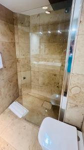 a bathroom with a shower and a toilet at Heefkant Haus Heefkant, HK 04 in Rantum