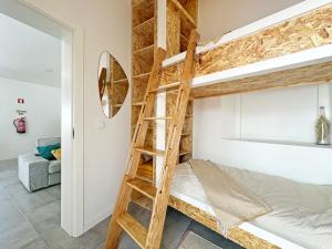 a room with a bunk bed and a ladder at Casa do Miradouro in São Bartolomeu do Outeiro