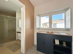 a bathroom with a shower and a window at Casa do Miradouro in São Bartolomeu do Outeiro +13 photos