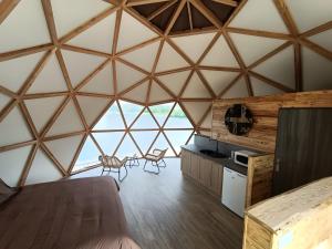 a room with a bed and chairs in a yurt at Les Gîtes De Robin'son in Foulcrey +24 photos
