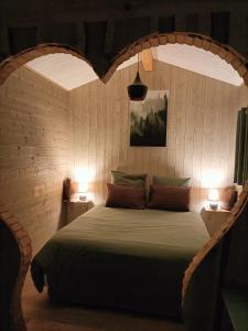 a bedroom with a bed with a heart shaped headboard at Les Gîtes De Robin'son in Foulcrey