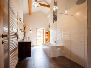 a bathroom with two sinks and a large mirror at Grasine 58 in Lake Pressegg +37 photos