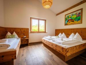 a bedroom with two beds and a window at Zattach 57 in Lake Pressegg