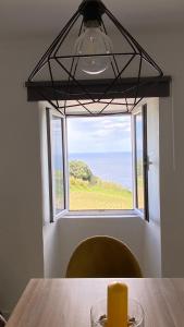 a candle sitting on a table in front of a window at Angelic Sea View in Bretanha