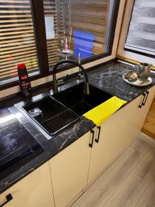 a kitchen counter with a sink and a window at Issyk-kul home in Korumdy +17 photos