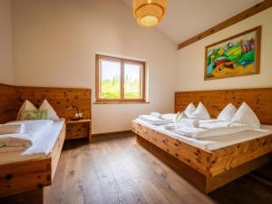 a bedroom with two beds and a window at Siwitz 55 in Lake Pressegg