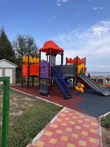 a playground with a slide in a park at Issyk-kul home in Korumdy