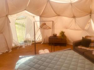 a room with a bed in a tent at Ebb Dome at Estuary Escapes in Kingsbridge