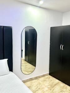 a bedroom with a mirror and a bed at Executive villa in Aja
