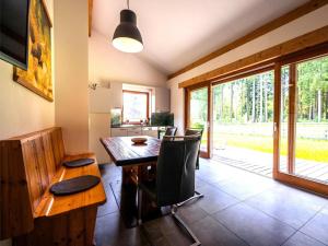 a dining room with a wooden table and chairs at Siwitz 55 in Lake Pressegg