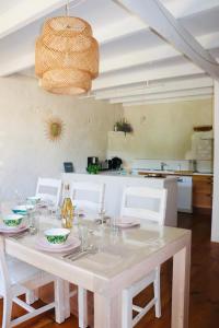 a dining room with a white table and chairs at Gite La Saintonge in Sainte-Gemme