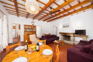 a living room with a table with wine glasses on it at Villa Trepuco Dos in Punta Prima