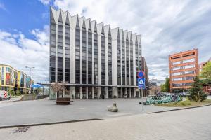 a large building with a sculpture in front of it at Bright Studio in Rotermann Quarter - Noor Apartment in Tallinn