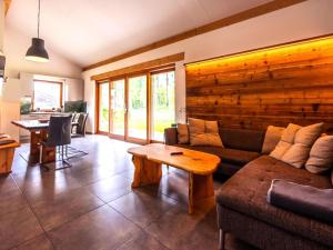 a living room with a couch and a table at Buchen 54 in Lake Pressegg