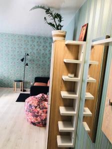 a staircase in a room with a plant on it at Apartment VV in Volodymyr-Volynskyi