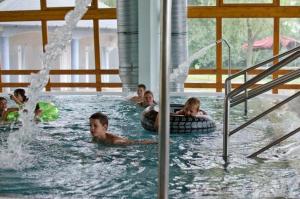 a group of children swimming in a swimming pool at Túrkeve Lakó in Túrkeve +9 photos