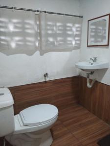 a bathroom with a toilet and a sink at DGH Jasaan in Jasaan +30 photos